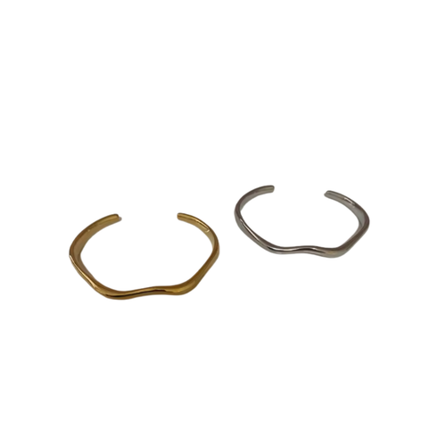 Two gold and silver wave shaped bangles on a white background