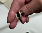 Hand holding two diamond rings with a blurred background