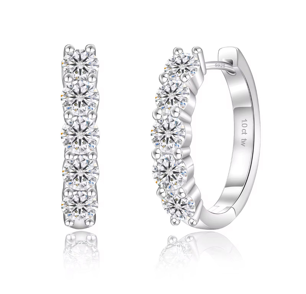 Pair of silver hoop earrings with clear gemstones on a white background