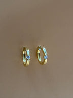mirelle earrings on an orange background