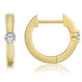 Gold hoop earring with a central gemstone on a white background