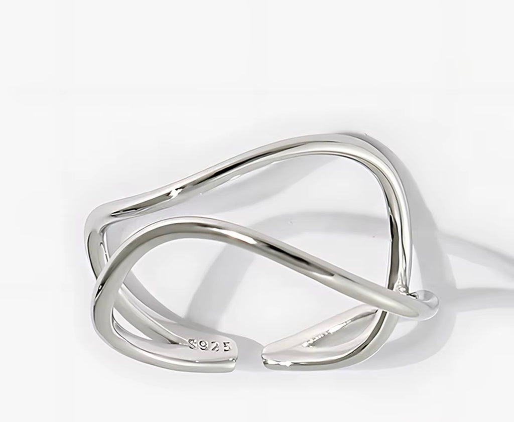 Silver ring with a modern design on a white background